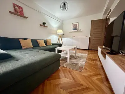 a living room with a couch and a table at Tilia in Zaječar