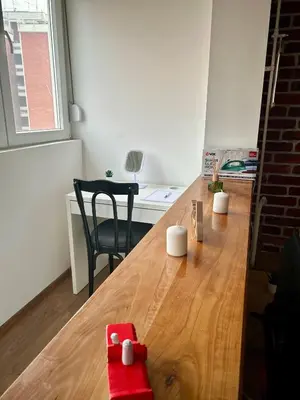 a room with a wooden table and a desk at Tilia in Zaječar