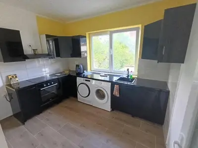 a kitchen with a sink and a washing machine at Tara in Surdulica