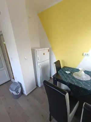 a small room with a table and a refrigerator at Tara in Surdulica