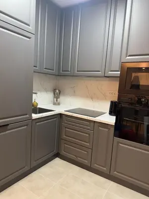 a kitchen with gray cabinets and a microwave at Stan na dan Bor Apartman in Bor