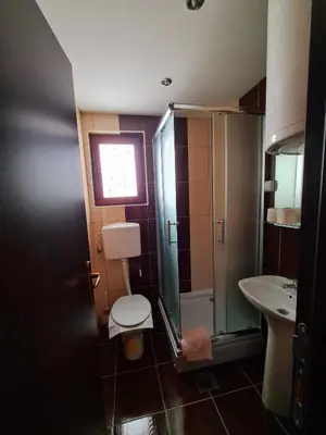 a bathroom with a toilet and a sink at VILA KRUNA Apartments in Kopaonik