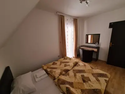 a bedroom with a bed in a room at VILA KRUNA Apartments in Kopaonik