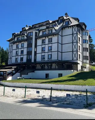 a large white building on top of a hill at SKI GOAT Kopaonik Centar vila Nikola in Kopaonik
