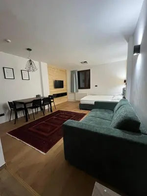 a living room with a couch and a bed at SKI GOAT Kopaonik Centar vila Nikola in Kopaonik