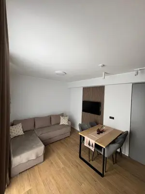 a living room with a couch and a table at Apartman IRIS Kopaonik in Kopaonik