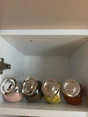 a row of four jars of food on a shelf at Apartman IRIS Kopaonik in Kopaonik