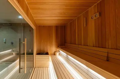 a sauna with wood paneling and a bath tub at Apartman IRIS Kopaonik in Kopaonik