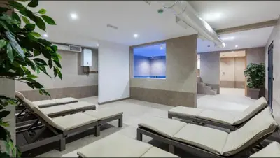 a hospital room with four beds and a window at Apartman IRIS Kopaonik in Kopaonik