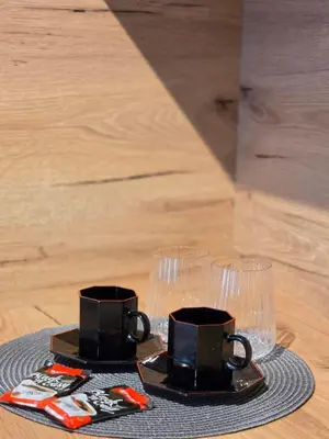 two cups and glasses sitting on a table at Apartman Raj VV sa garazom in Vrnjci