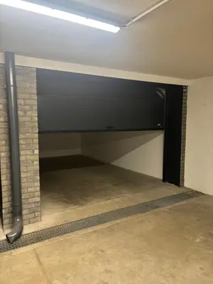 a room with a garage with a brick wall at Apartman Raj VV sa garazom in Vrnjci