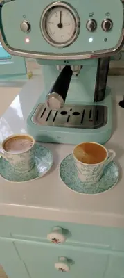 a coffee maker with two cups and a clock at Šumarac
