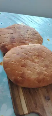 two biscuits sitting on a wooden cutting board at Šumarac