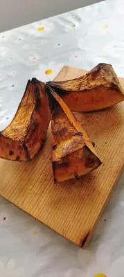 two pieces of food on a wooden cutting board at Šumarac