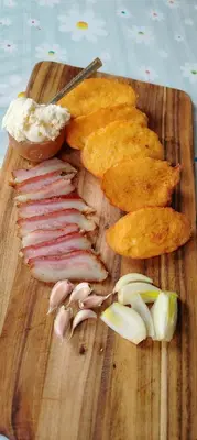 a cutting board with bacon and other foods on it at Šumarac