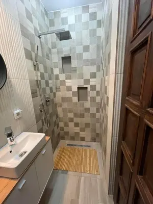 a bathroom with a shower and a sink at Ćilibar Stara planina in Crni Vrh