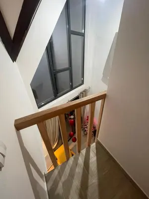 a stairway with a window and a stair case at Ćilibar Stara planina in Crni Vrh