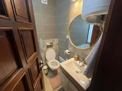 a bathroom with a toilet and a sink and a mirror at Ćilibar Stara planina in Crni Vrh