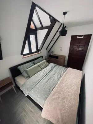a bedroom with a bed and a large window at Ćilibar Stara planina in Crni Vrh