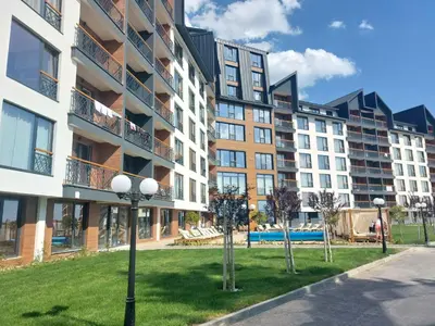 an apartment building with trees in front of it at Apartman MM84b Residence Hill in Lisina