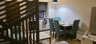 a kitchen and dining room with a table and chairs at Apartman MM84b Residence Hill in Lisina