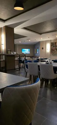 a restaurant with tables and chairs in a room at Apartman MM84b Residence Hill in Lisina