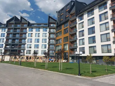 an apartment building with a park in front of it at Apartman MM84b Residence Hill in Lisina