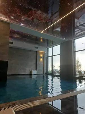 a large indoor swimming pool in a building at Apartman MM84b Residence Hill in Lisina