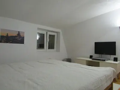a bedroom with a bed and a flat screen tv at BeleStaze88 in Brzeće