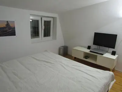 a bedroom with a bed and a desk with a television at BeleStaze88 in Brzeće