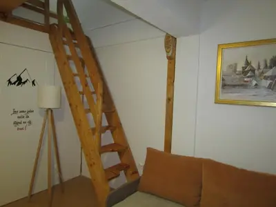 a living room with a staircase and a couch at BeleStaze88 in Brzeće