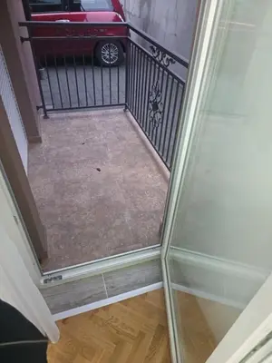 a stairway with a glass door with a car on it at DA apartman in Vrnjačka Banja