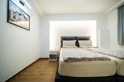 a bedroom with a bed and a tv on the wall at Vila Vrnjačka Banja in Vrnjačka Banja