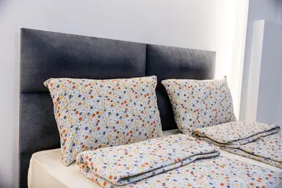 a couch with two pillows on top of it at Vila Vrnjačka Banja in Vrnjačka Banja
