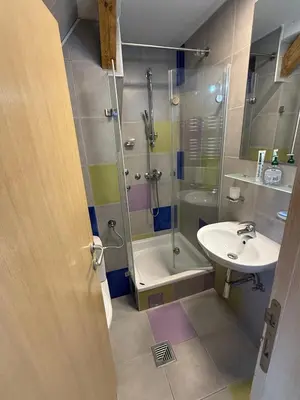 a bathroom with a shower and a sink at Konaci Spacious Studio in the Heart of the Slopes in Kopaonik