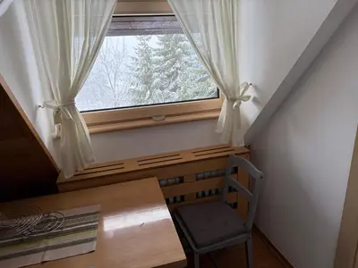 a window in a room with a desk and a chair at Konaci Spacious Studio in the Heart of the Slopes in Kopaonik