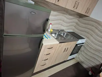 a small kitchen with a sink and a refrigerator at PODNOZJe KOPAONIKA in Brus