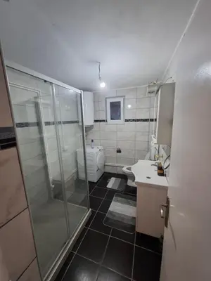a bathroom with a shower and a sink and a toilet at PODNOZJe KOPAONIKA in Brus