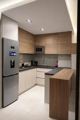 a kitchen with stainless steel appliances and wooden cabinets at Leo Lux 3 in Niš
