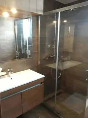 a bathroom with a glass shower and a sink at Blue Sky in Bukorovac