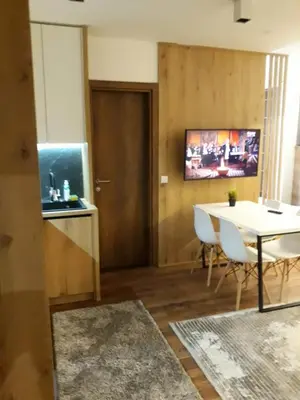 a living room with a table and a dining room at Blue Sky in Bukorovac
