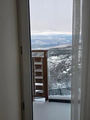 a room with a window with snow on the ground at Sky Nest Kopaonik in Kopaonik