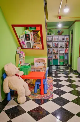 a teddy bear sitting on a table in a room at Vila369 in Pirot