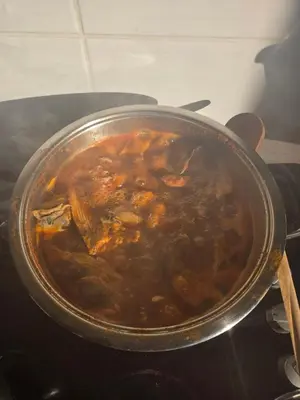 a pot of food on top of a stove at Koliba boema in Despotovac