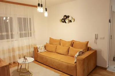 a living room with a couch and a table at Apartman Wish Lux in Vrnjci