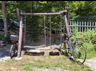 a bike parked next to a swing at Kalina in Vlasina Okruglica