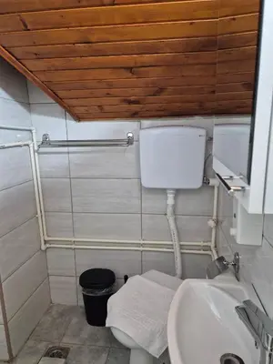 a bathroom with a toilet and a sink at Niš Residence in Niš