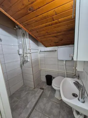 a bathroom with a toilet and a sink at Niš Residence in Niš