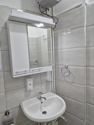 a bathroom with a sink and a mirror at Niš Residence in Niš
