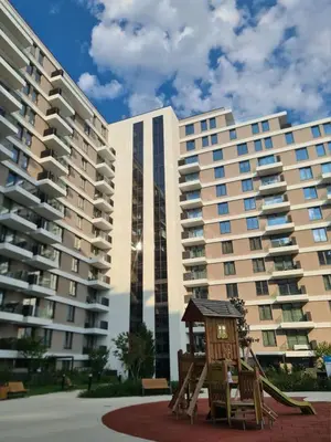 a playground in front of a large apartment building at Planet Residence Deluxe Wellnes & Spa Apartment in Niš